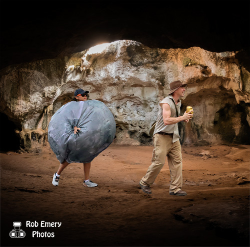 Indiana Jones running from a boulder in a cave